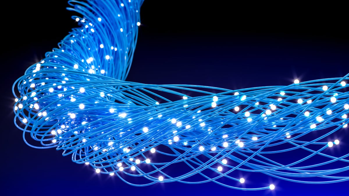 Blue fiber optic cables illustrating global network communication and digital technology